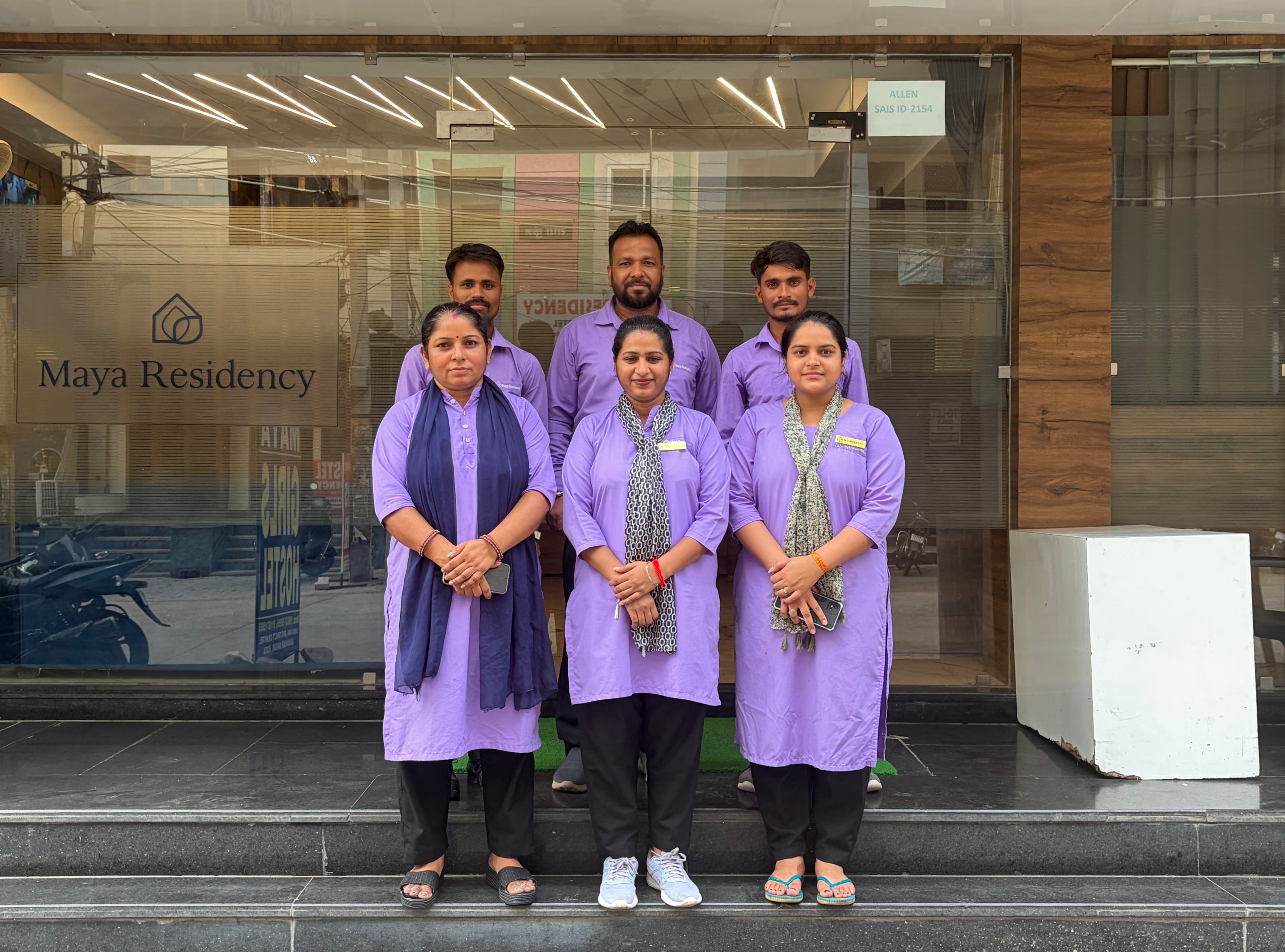 The Maya Residency staff team at the hostel entrance
