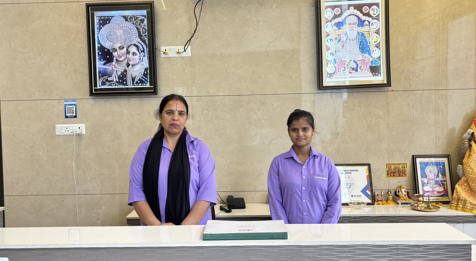 Reception staff at the Maya Residency front desk