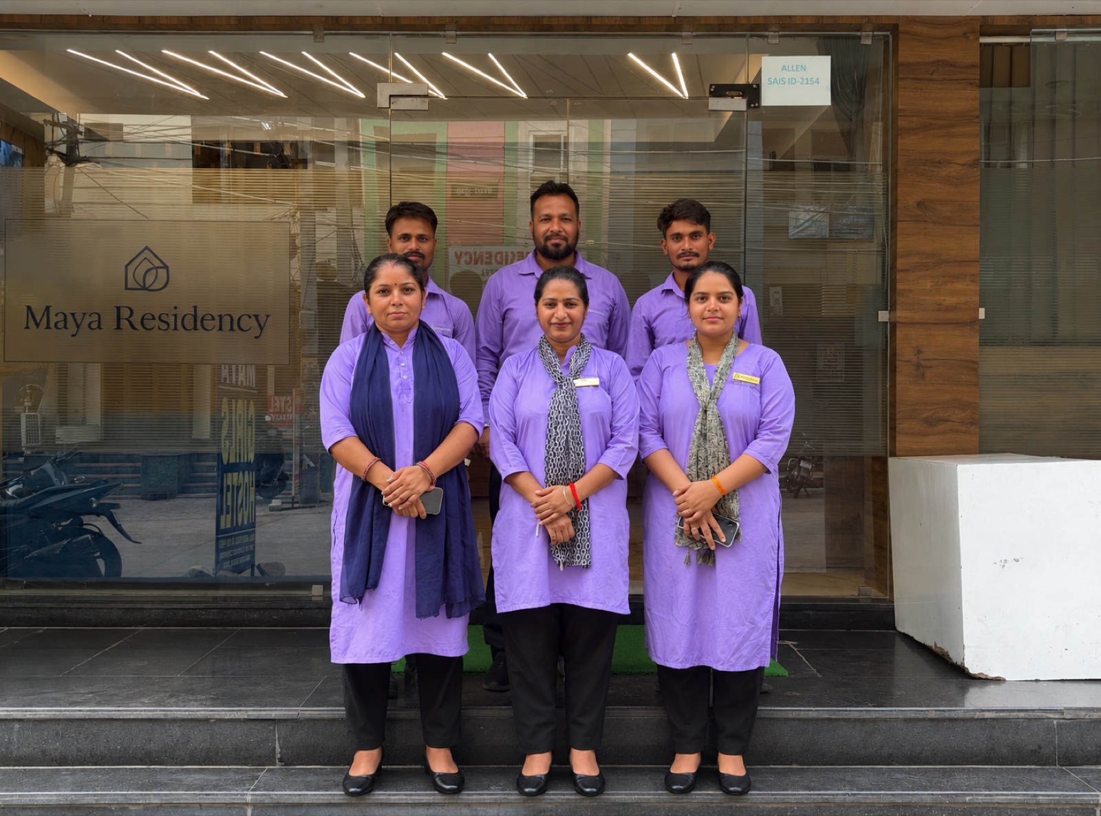 The Maya Residency staff team at the hostel entrance